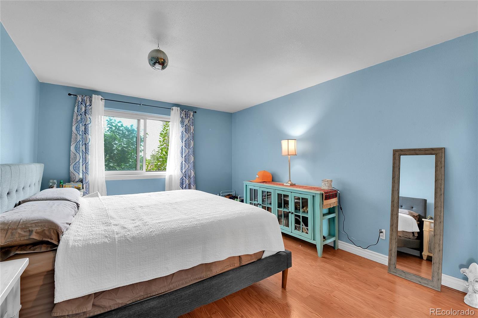 8470 Decatur Street, Unit 80 Westminster, CO 80031 - Photo 16 of 28 a bedroom with a bed and a window