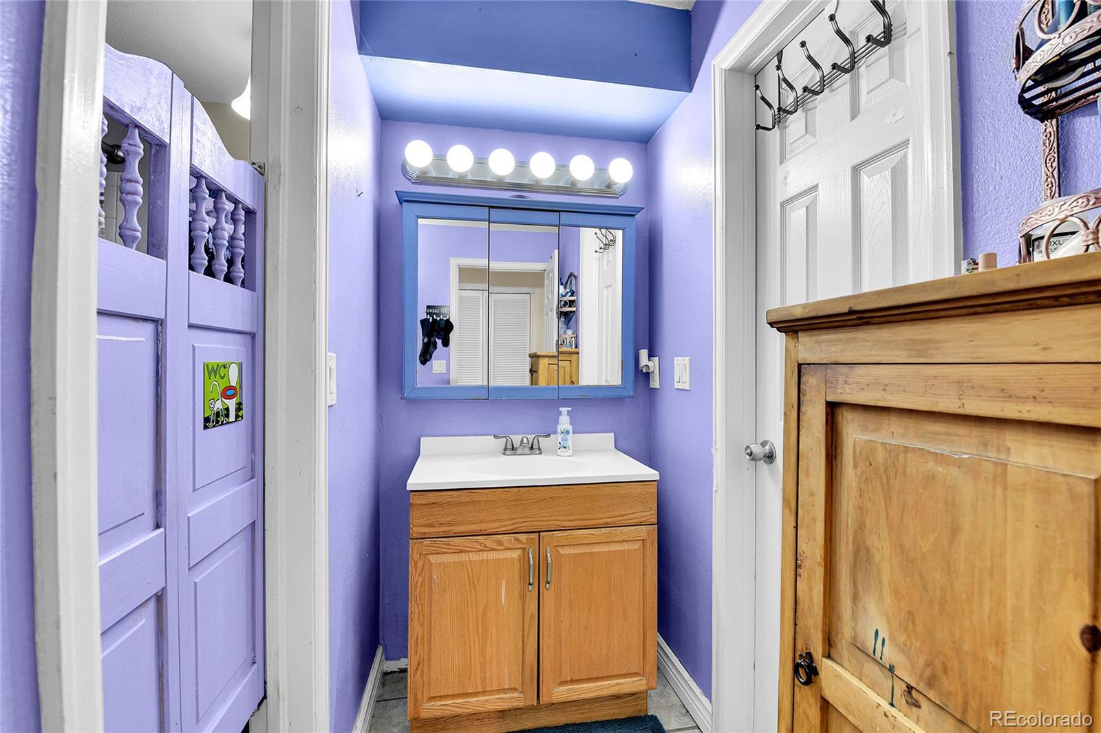 8470 Decatur Street, Unit 80 Westminster, CO 80031 - Photo 17 of 28 a bathroom with a sink and a mirror