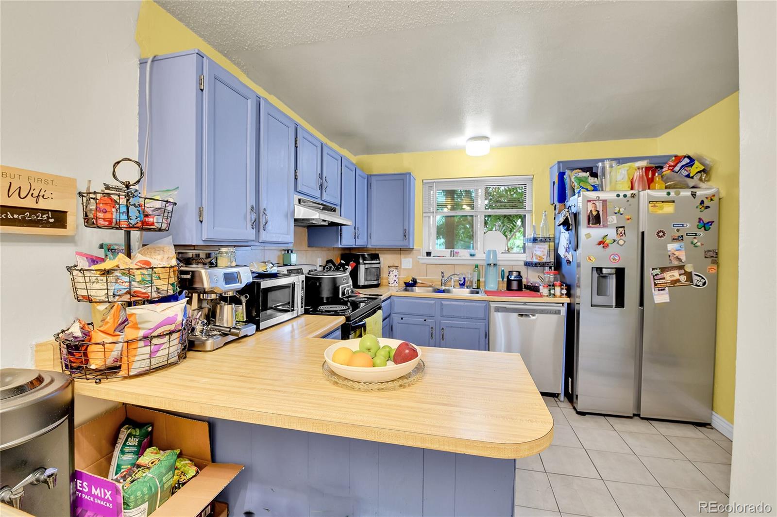 8470 Decatur Street, Unit 80 Westminster, CO 80031 - Photo 4 of 28 a kitchen with stainless steel appliances wooden floor dining table and chairs