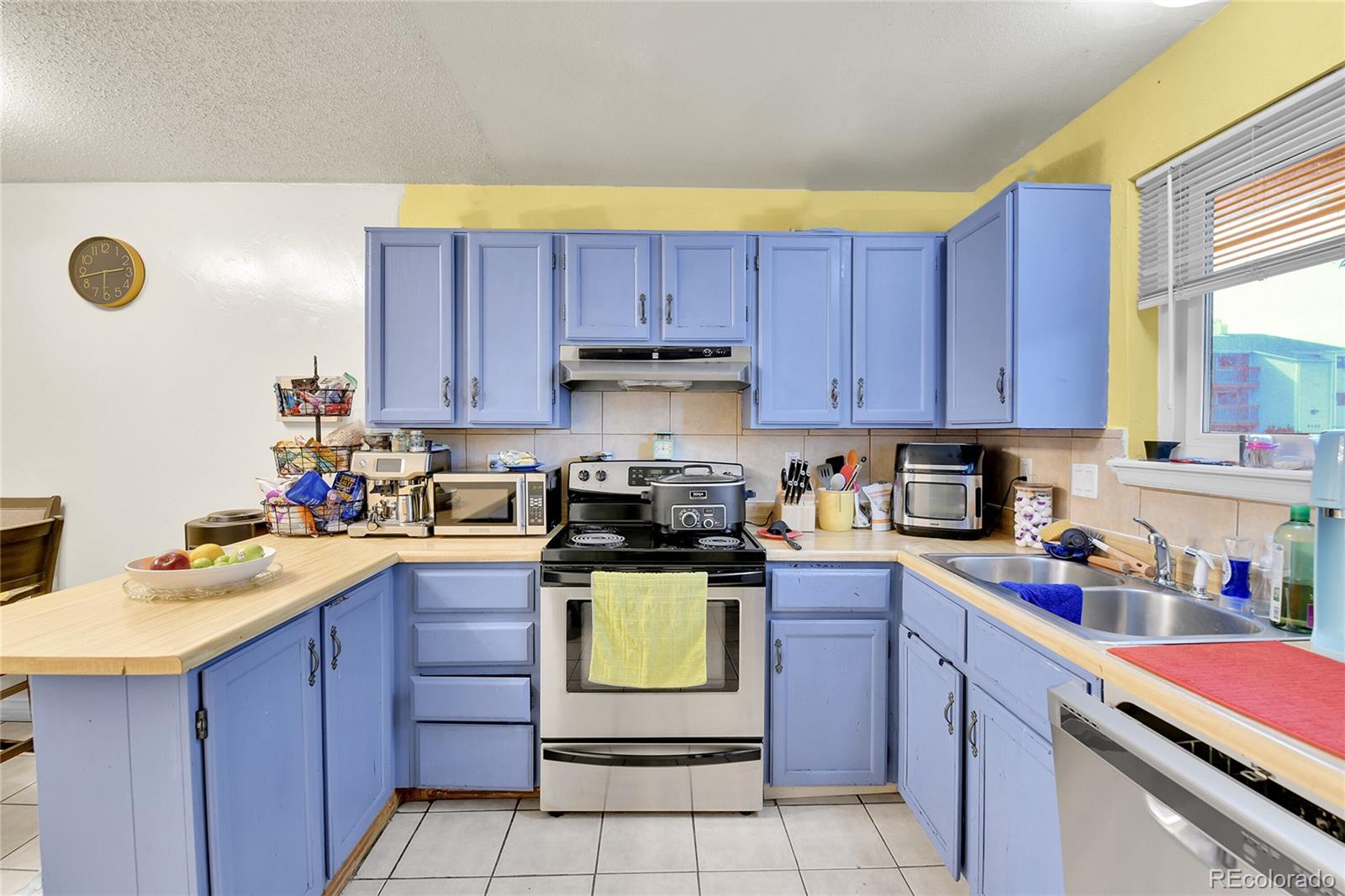 8470 Decatur Street, Unit 80 Westminster, CO 80031 - Photo 5 of 28 a kitchen with a sink a stove and cabinets