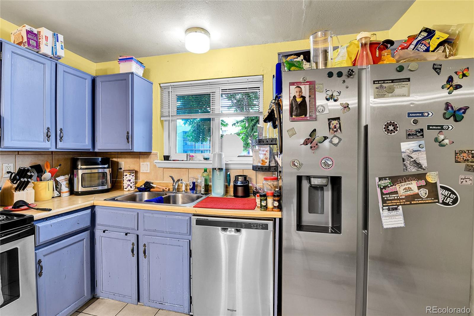 8470 Decatur Street, Unit 80 Westminster, CO 80031 - Photo 6 of 28 a utility room with refrigerator and cars