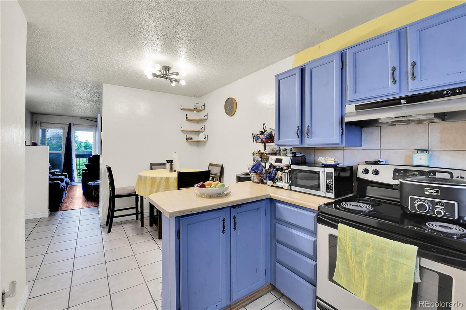 8470 Decatur Street, Unit 80 Westminster, CO 80031 - Photo 7 of 28 a kitchen with a stove a sink and cabinets