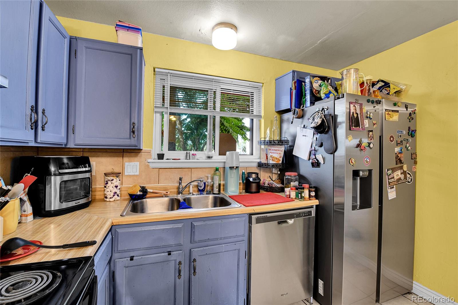 8470 Decatur Street, Unit 80 Westminster, CO 80031 - Photo 8 of 28 a kitchen with stainless steel appliances a refrigerator and sink