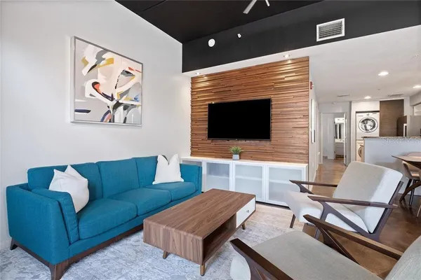 a living room with furniture and a flat screen tv