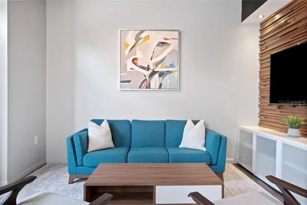 a living room with furniture and a flat screen tv