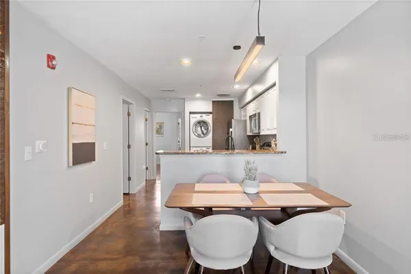 a living room with toilet a sink and a window