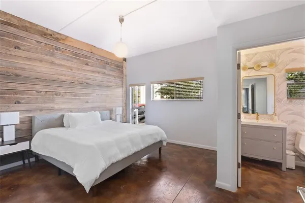 a bedroom with a bed and a table