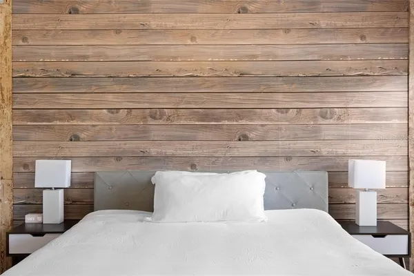 a bedroom with a bed and lamp