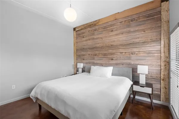 a bedroom with a bed and a table