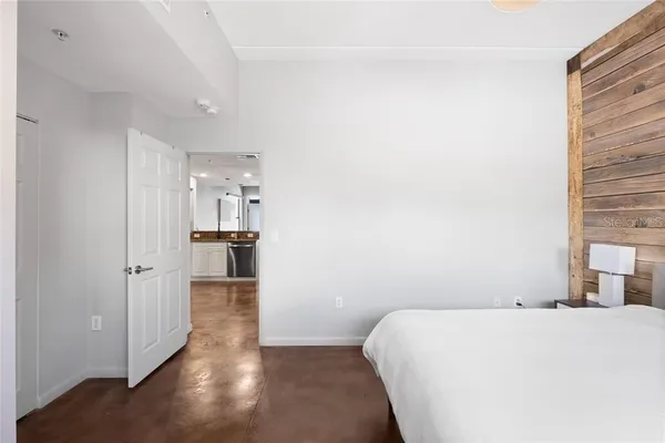 a view of a bedroom with wooden floor