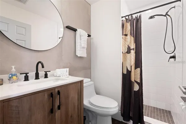 a bathroom with a sink toilet and shower