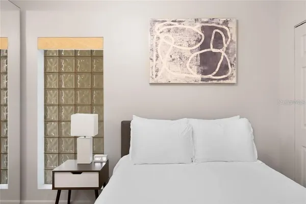 a bedroom with a bed and a window