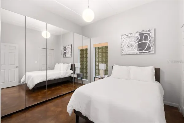 a bedroom with a large bed and a couch