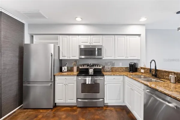 a kitchen with a refrigerator stove and microwave