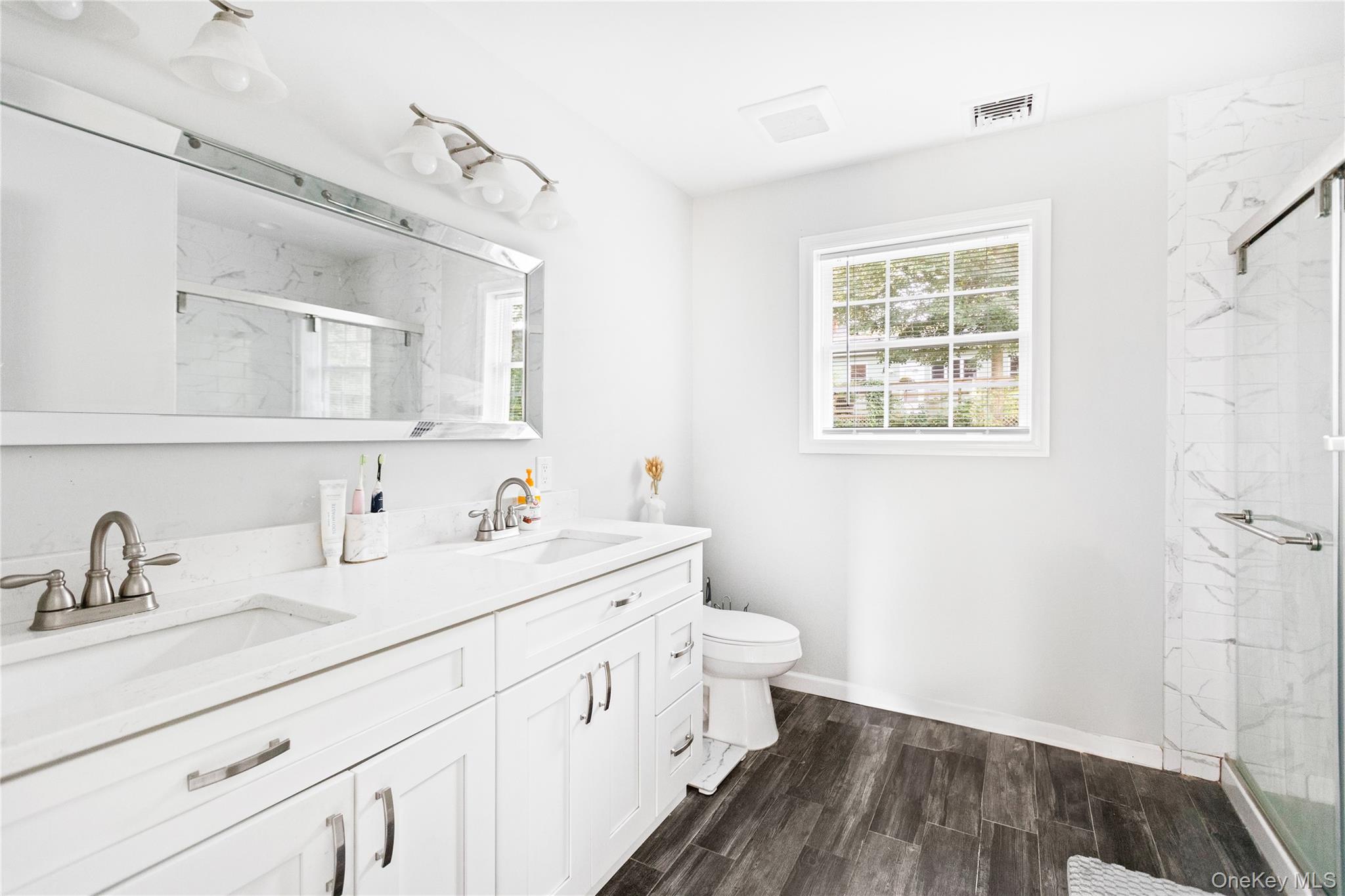 24 Belmont Road Sound Beach, NY 11789 - Photo 14 of 23 a bathroom with 2 sink and a mirror