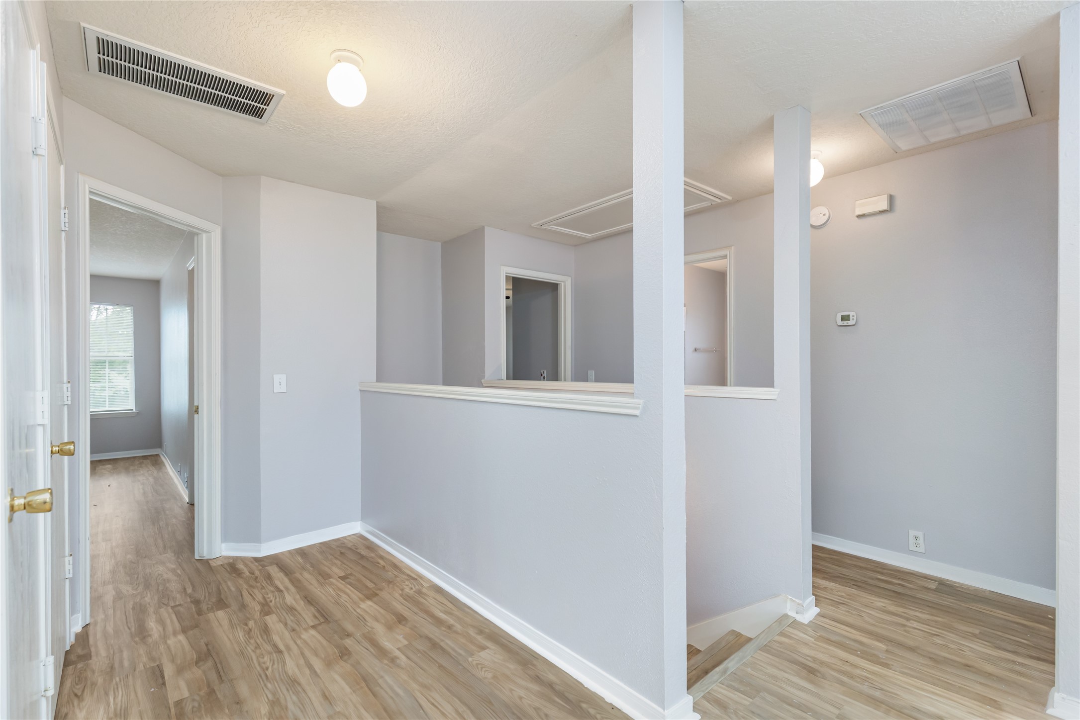 17334 Turquoise Stream Drive Houston, TX 77095 - Photo 19 of 31 a view of a hallway with wooden floor and closet