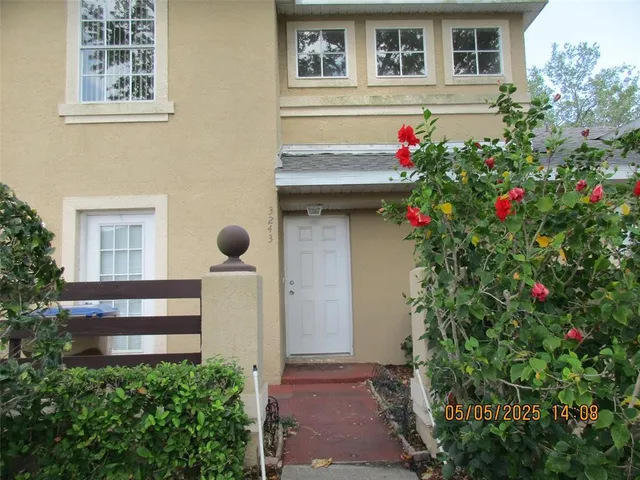 a front view of a house with a flower garden