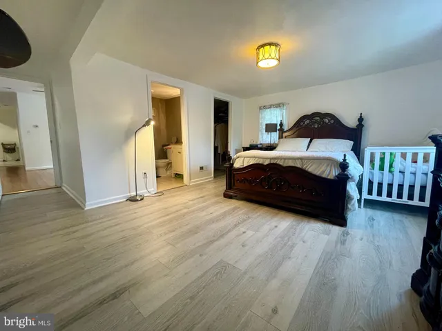 a spacious bedroom with a bed and a walk in closet