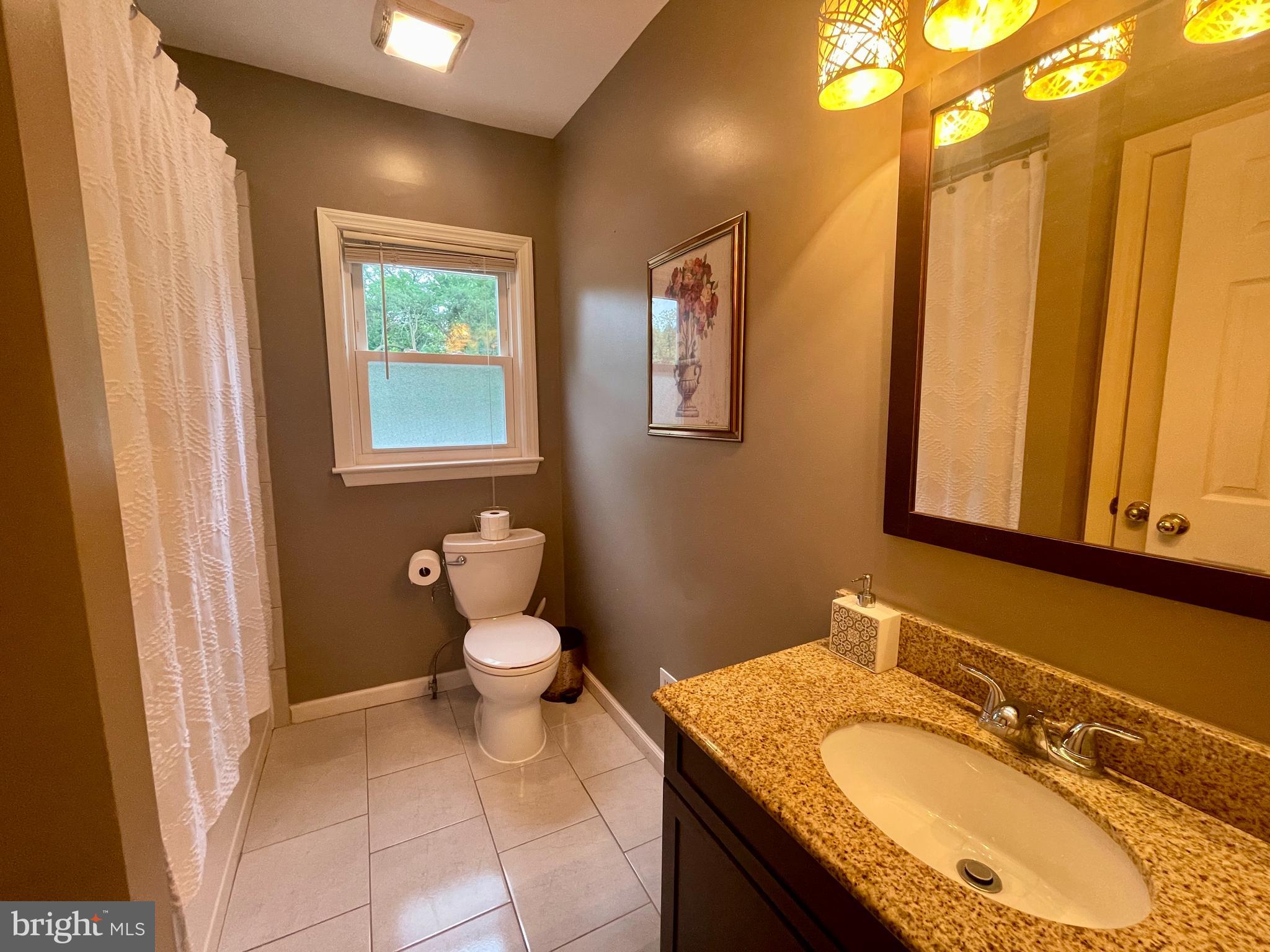 39 Mabel Street Ewing, NJ 08638 - Photo 15 of 33 a bathroom with a granite countertop sink and a mirror