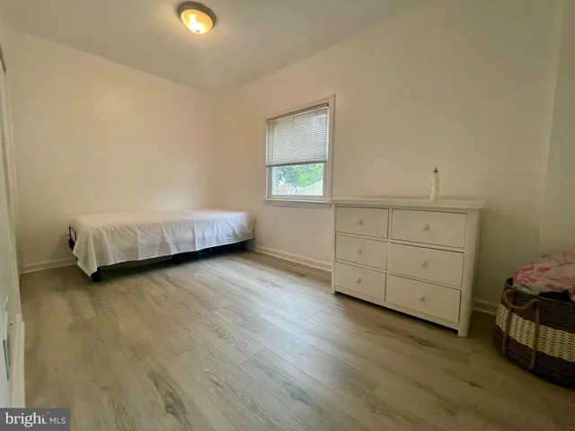 a view of room with furniture and wooden floor
