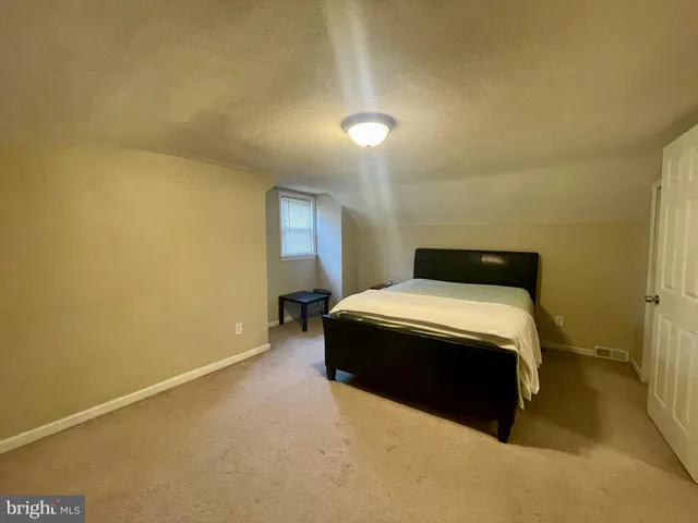 a bedroom with a bed and a night stand