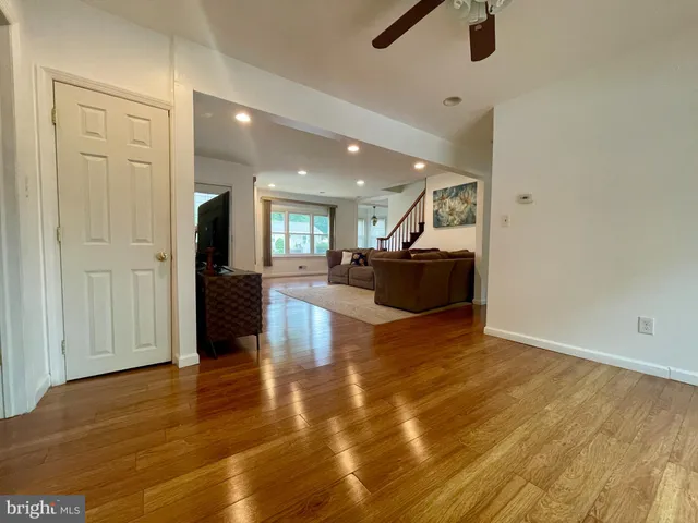 a view of an empty room and kitchen view