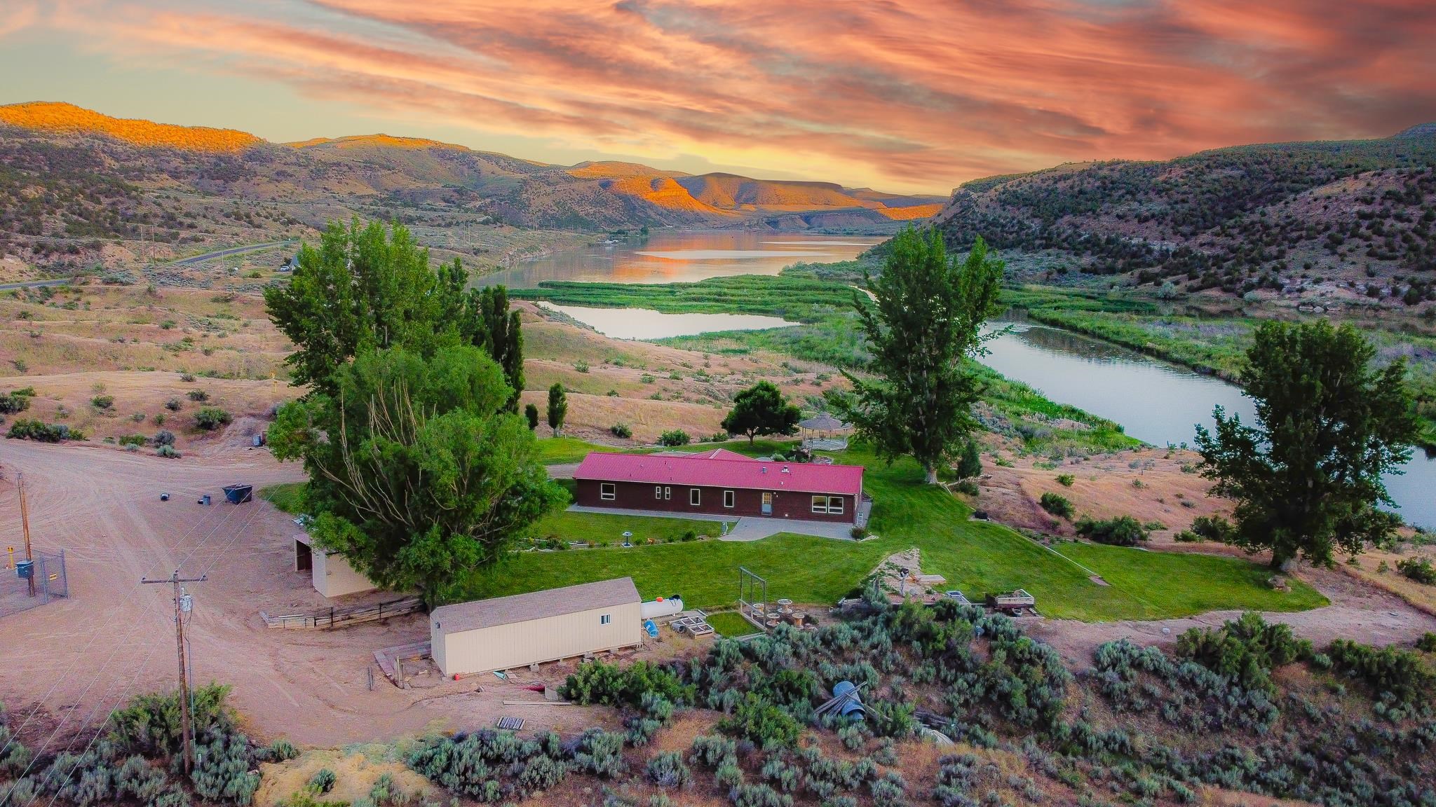 24591 Highway 64 Rangely, CO 81648 - Photo 1 of 42 a backyard of a house with lots of green space