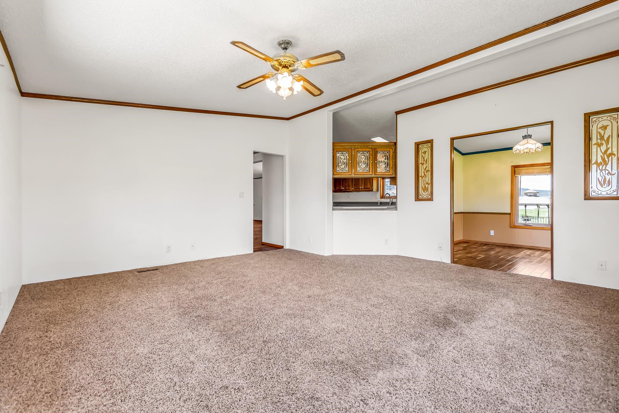 24591 Highway 64 Rangely, CO 81648 - Photo 18 of 42 a view of a livingroom with a ceiling fan and window