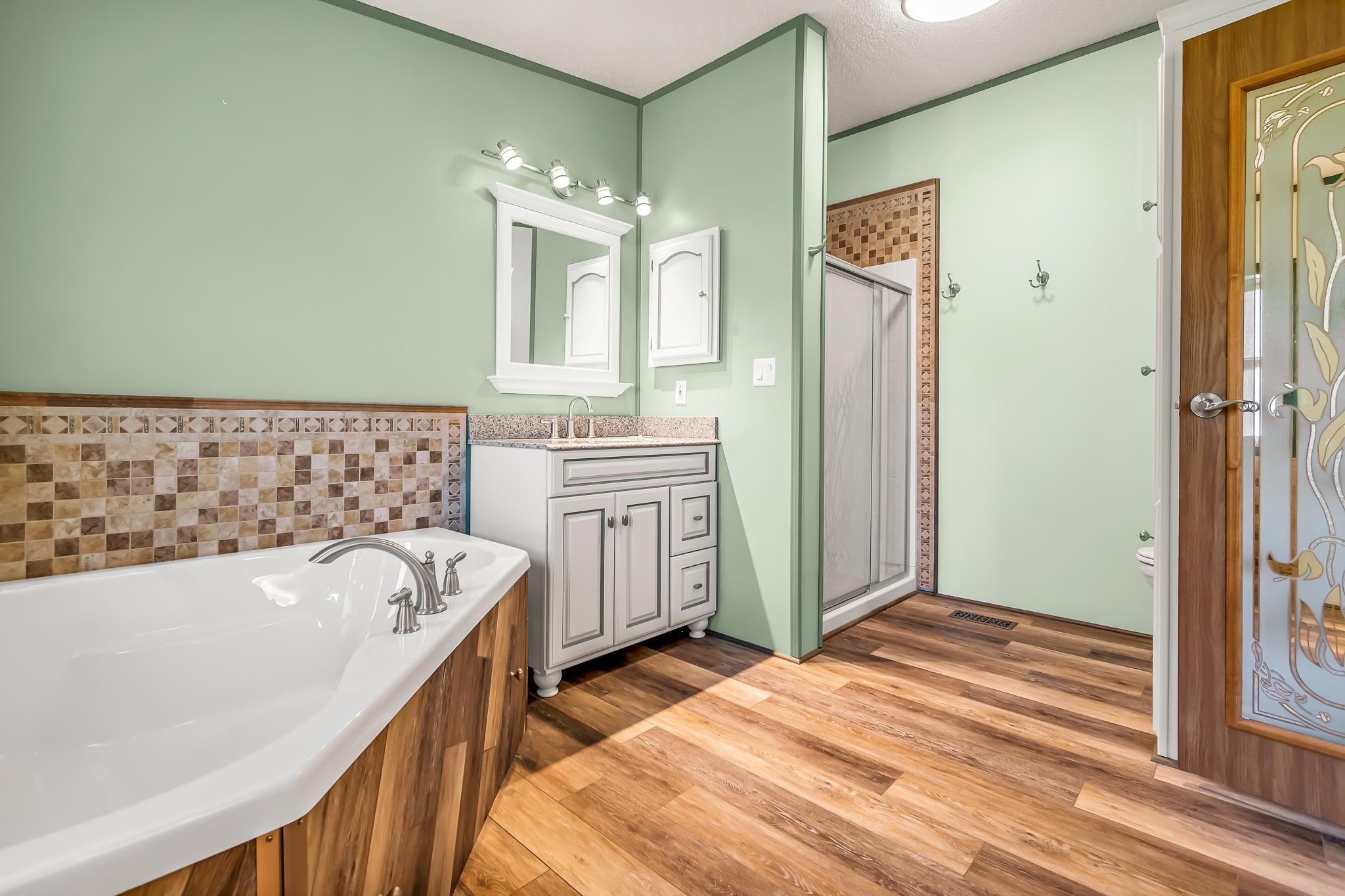 24591 Highway 64 Rangely, CO 81648 - Photo 23 of 42 a bathroom with a bathtub sink and mirror