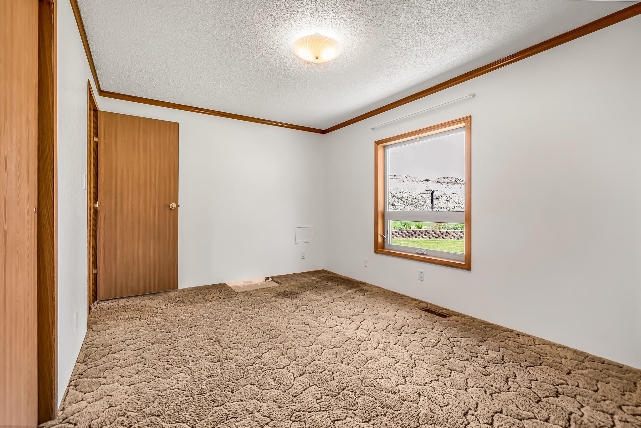 24591 Highway 64 Rangely, CO 81648 - Photo 25 of 42 an empty room with a window