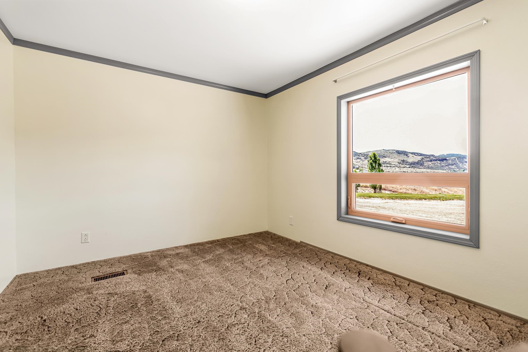 24591 Highway 64 Rangely, CO 81648 - Photo 29 of 42 a view of a big room with wooden floor and a window