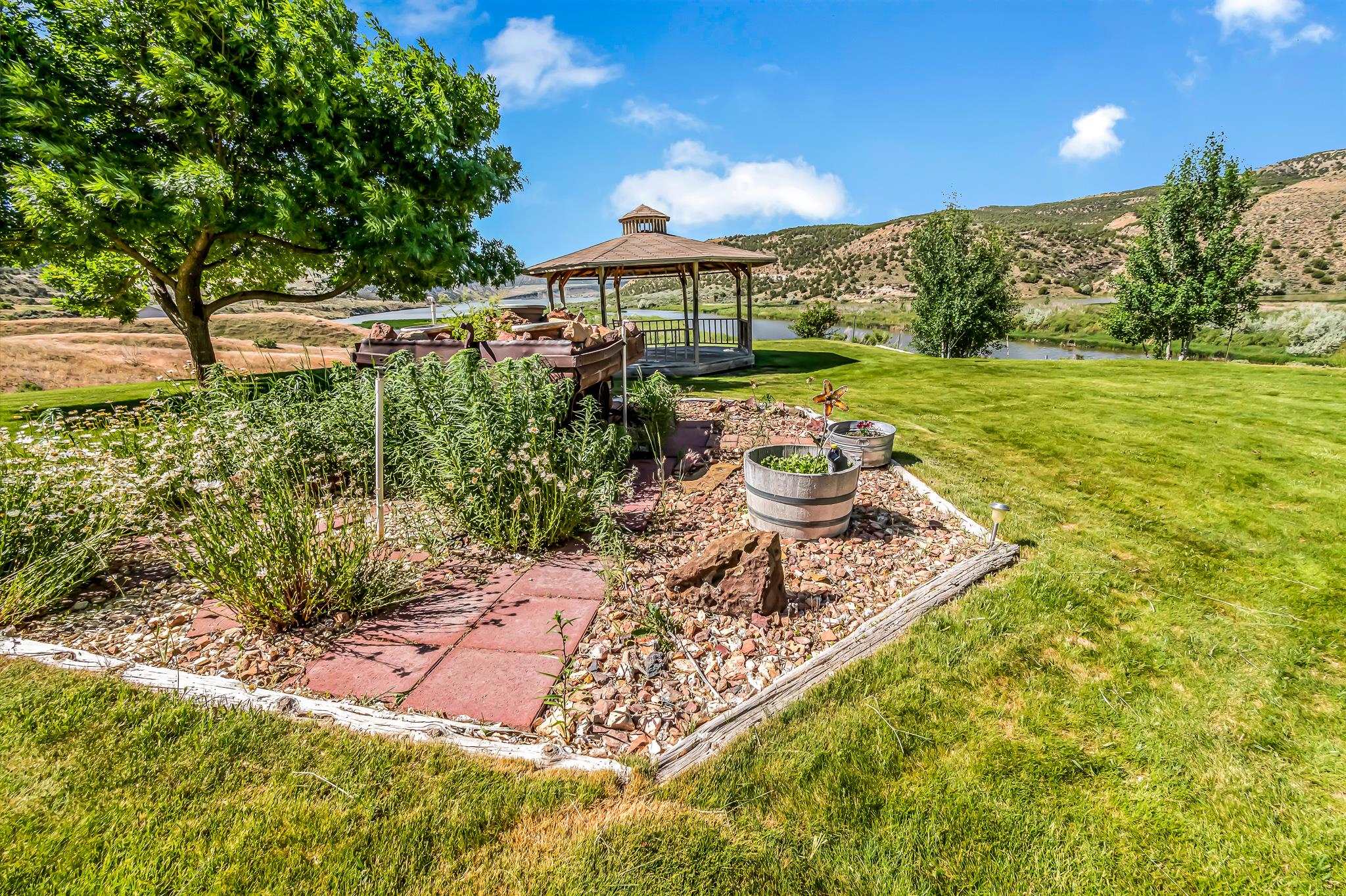 24591 Highway 64 Rangely, CO 81648 - Photo 30 of 42 a view of a backyard with plants and lake view