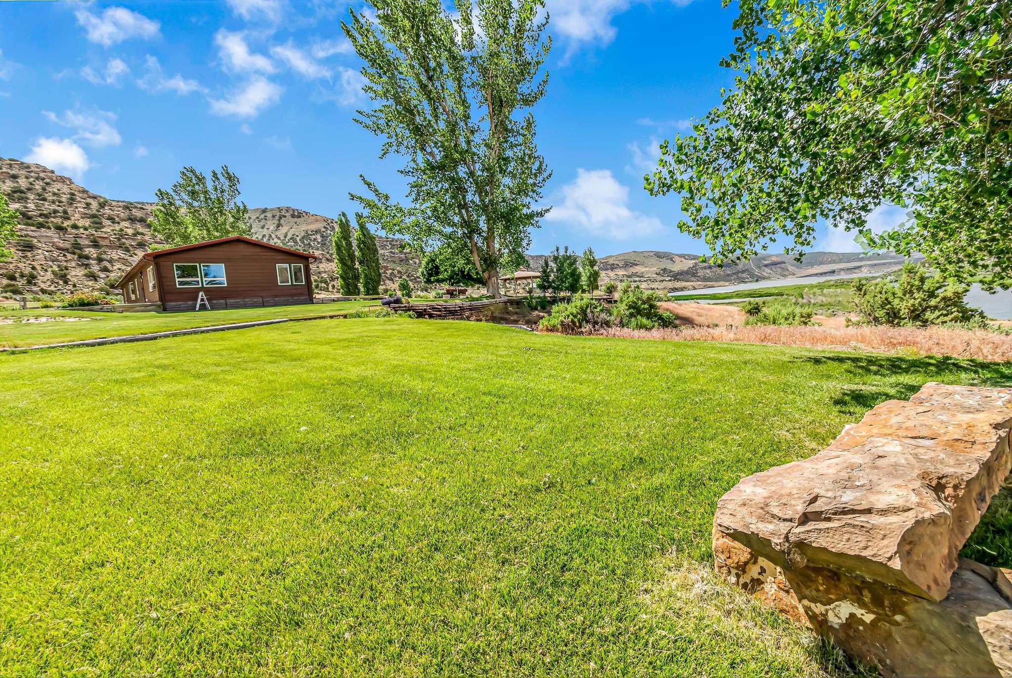 24591 Highway 64 Rangely, CO 81648 - Photo 33 of 42 a view of a garden with a building in the background