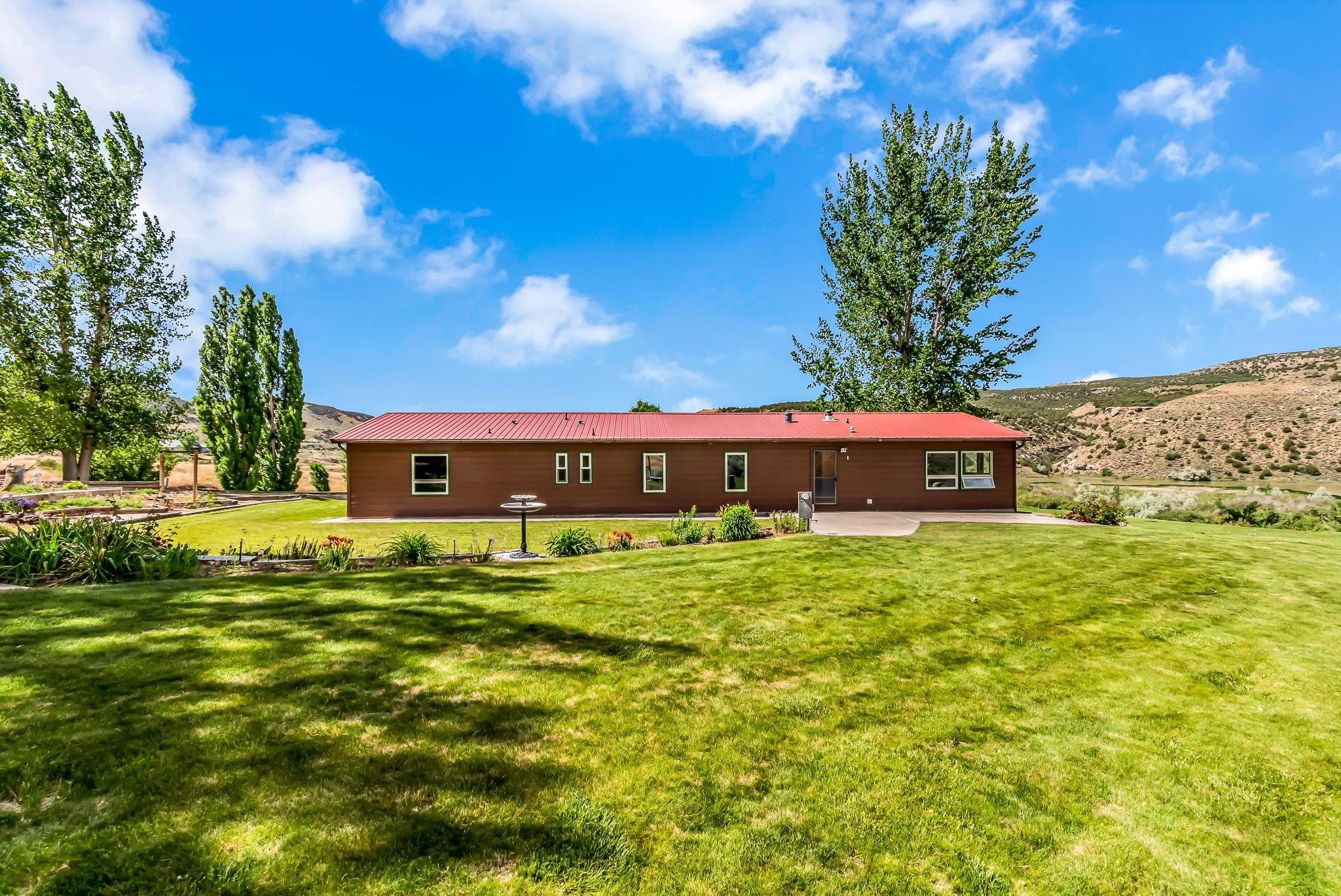 24591 Highway 64 Rangely, CO 81648 - Photo 35 of 42 a outdoor view of a house with a garden