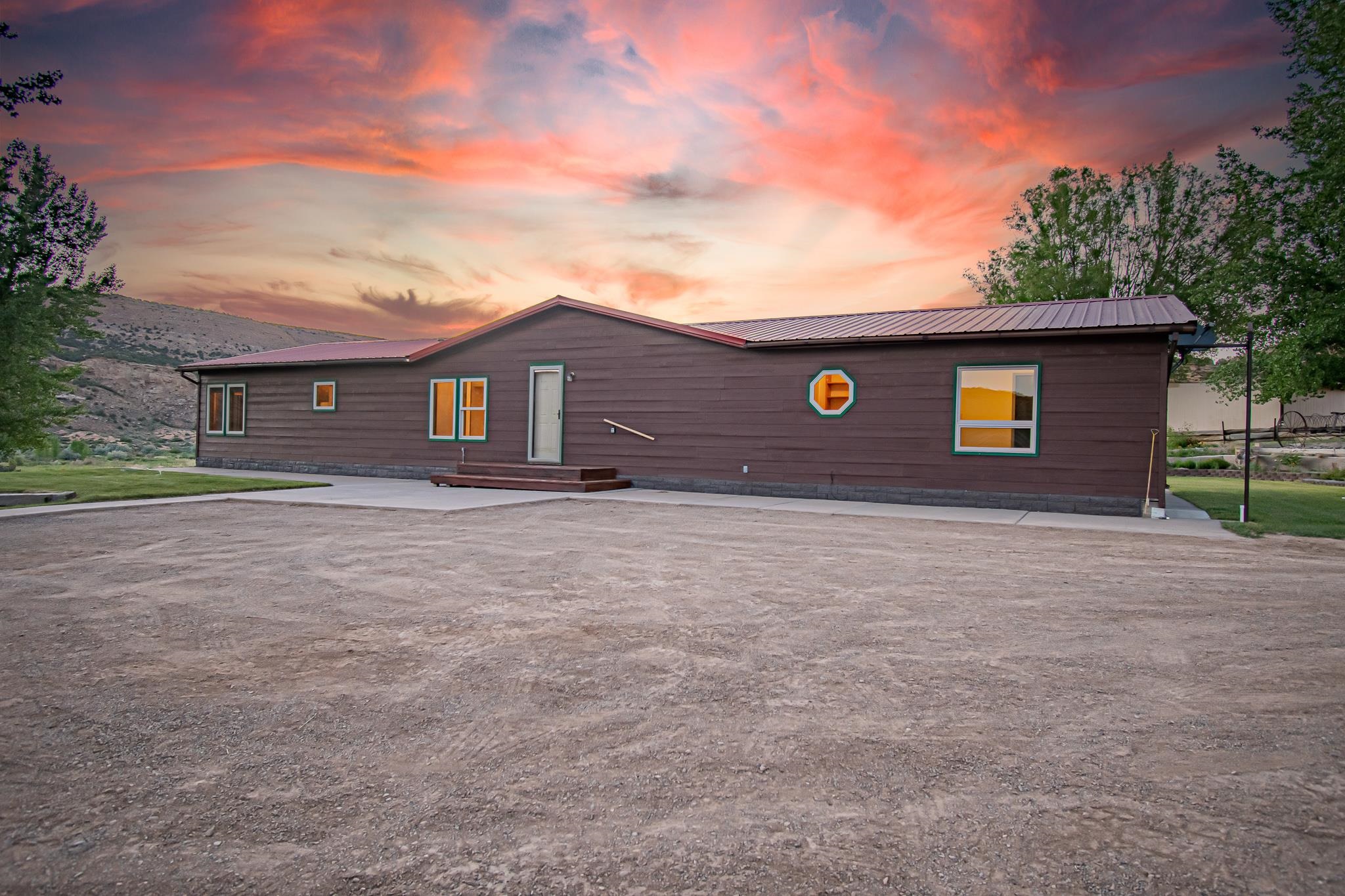 24591 Highway 64 Rangely, CO 81648 - Photo 40 of 42 a front view of a house with a yard