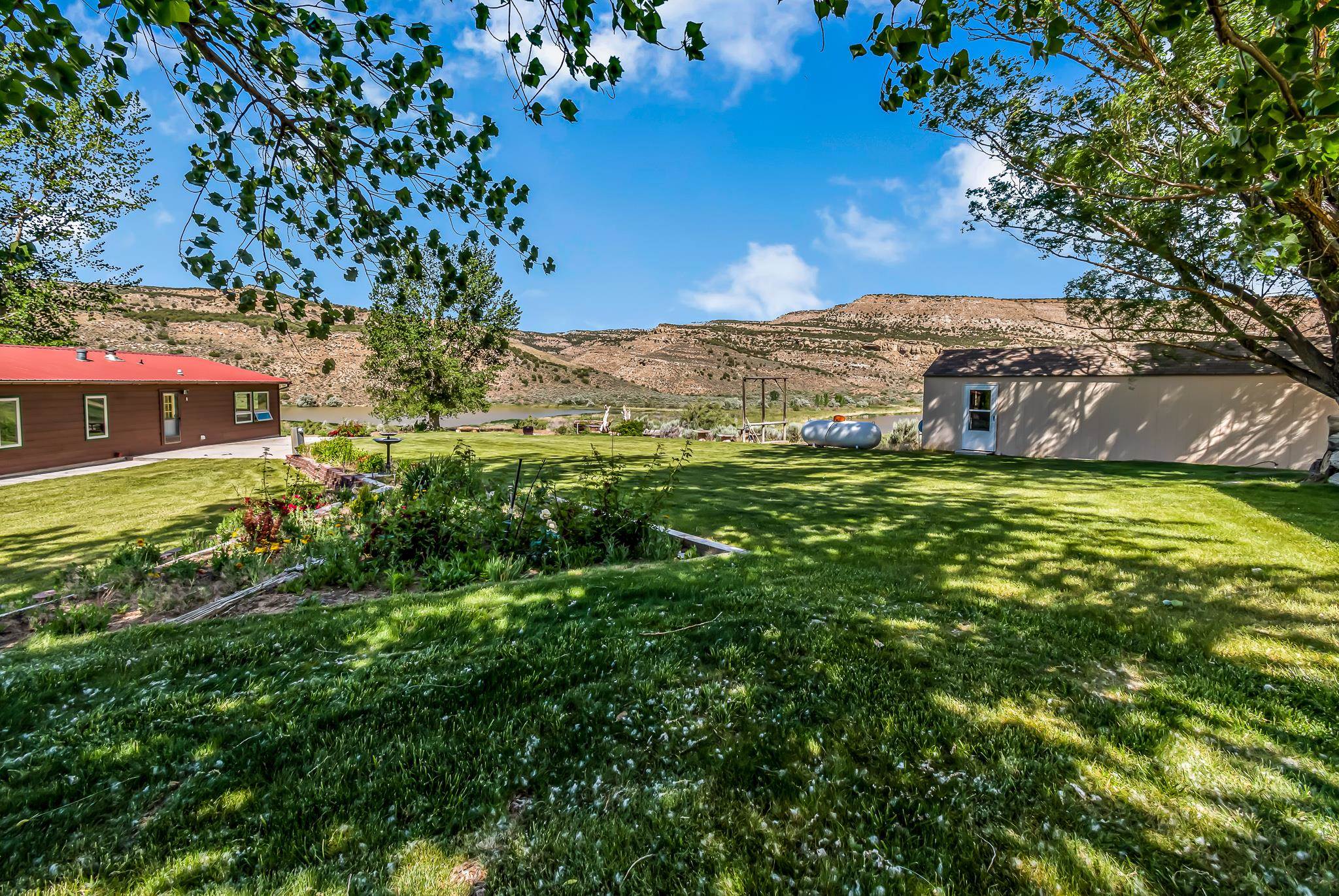 24591 Highway 64 Rangely, CO 81648 - Photo 7 of 42 a view of a big yard with large trees