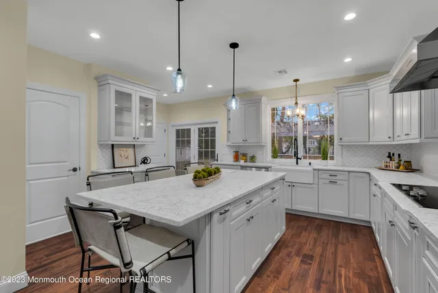 a kitchen with a table chairs sink and cabinets