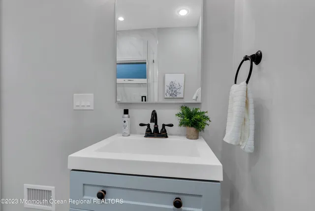 a bathroom with a sink a mirror and vanity
