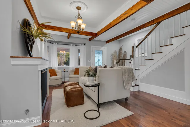 a living room with furniture and a chandelier