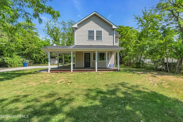 a view of a house with a yard patio and deck