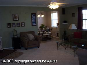 4207 Camp Lane Amarillo, TX 79110 - Photo 2 of 11 a living room with furniture a large window and a chandelier