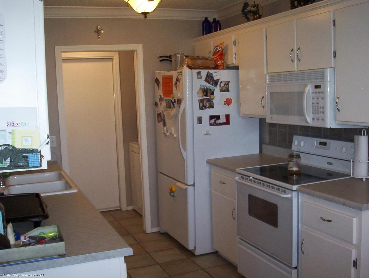 4207 Camp Lane Amarillo, TX 79110 - Photo 4 of 11 a kitchen with a stove and a refrigerator