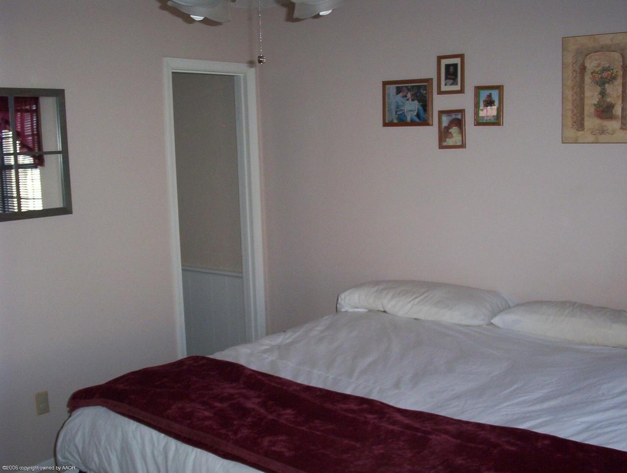 4207 Camp Lane Amarillo, TX 79110 - Photo 7 of 11 a bedroom with a bed and wall painting