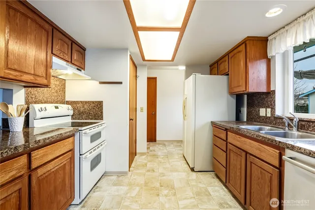 a kitchen with a sink stove and refrigerator