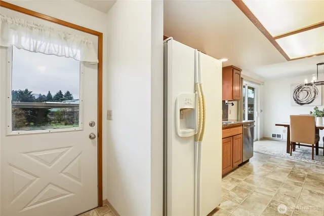 a view of kitchen with a refrigerator and cabinets