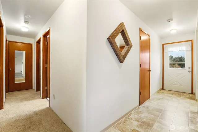 a view of a hallway to rooms