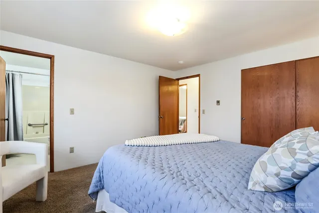 a bedroom with a bed and a couch