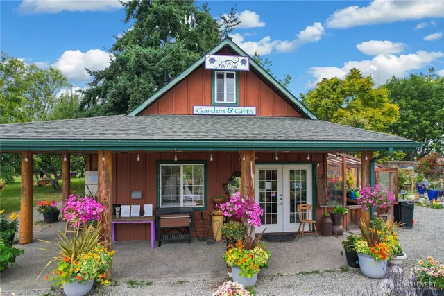 a front view of a house with plants