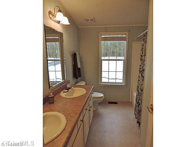 743 Lazy Branch Road Ennice, NC 28623 - Photo 11 of 16 Other Bath. Full tub and two-sink vanity helps everyone to move fast in the mornings!