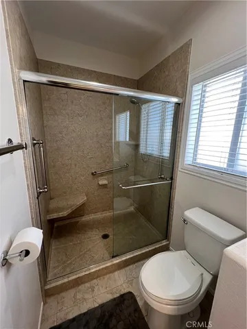 a bathroom with a toilet and a shower